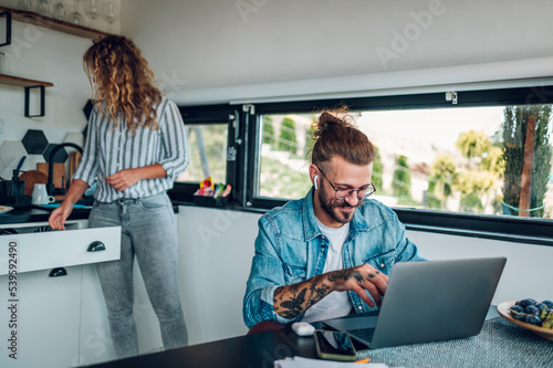 Couple working from home and spending time together in the kitchen