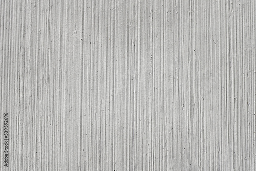 Textured abstract background with brush strokes and lines. Close-up of the texture of grey paint on the wall