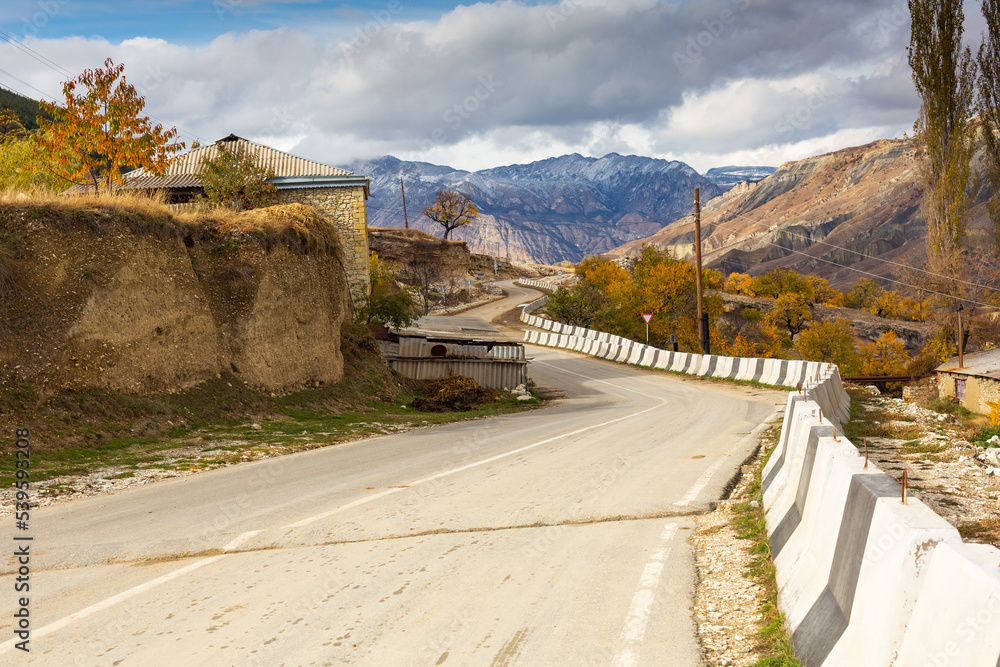 Asphalt road in the town of Salta, Dagestan, Russia. Autumn landscape and highway. The road among the mountains