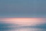 Abstract landscape. Blue background. Serene ocean water and pink sun light