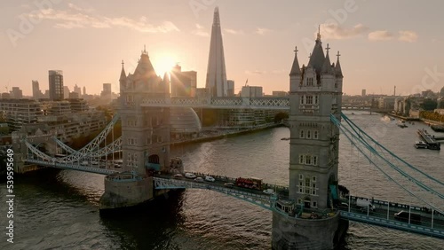 Iconic Tower Bridge at sunset. Connecting London with Southwark on the Thames River. Aerial sunset view of London city center and the Tower bridge of London.  photo