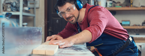 Billede på lærred Professional carpenter working machine at shop. Banner design