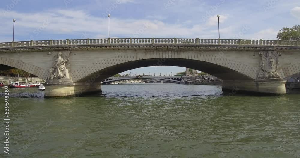 Bateau-mouche sailing on the Seine and passing under the Pont des Invalides toward the Pont Alexandre III in Paris. Bateau-mouche sailing on the Seine and passing under the Pont des Invalides toward the Pont Alexandre III in Paris.
