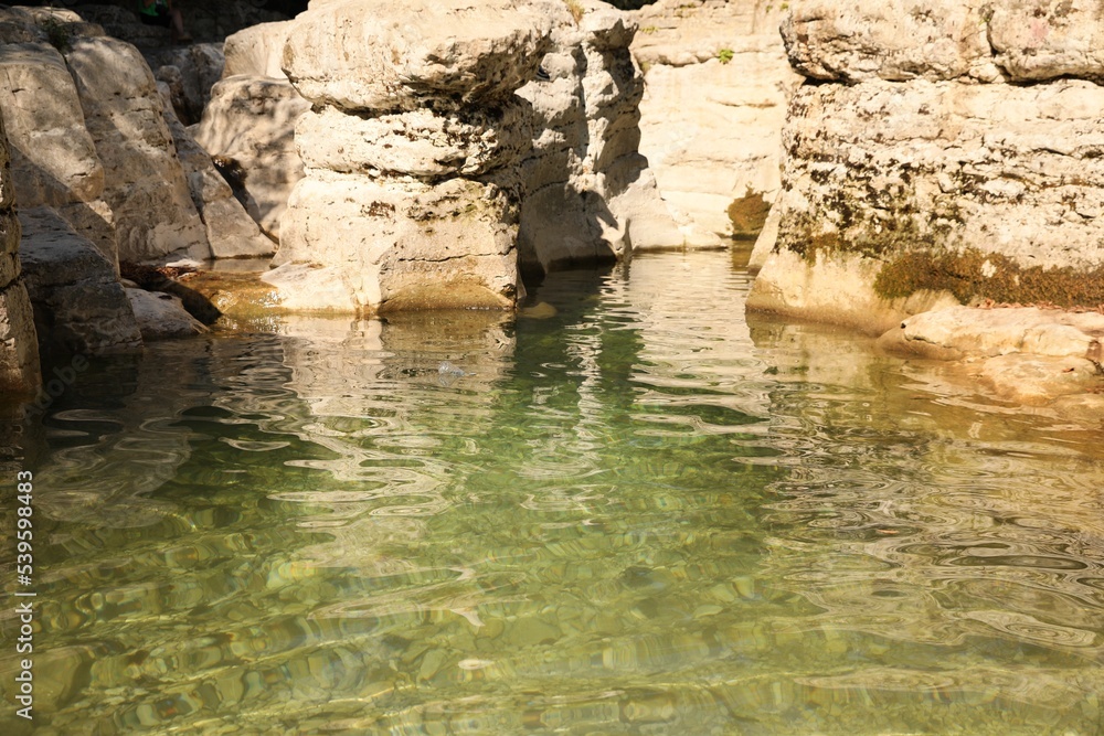 Beautiful clean pond and many rocks outdoors Beautiful clean pond and many rocks outdoors
