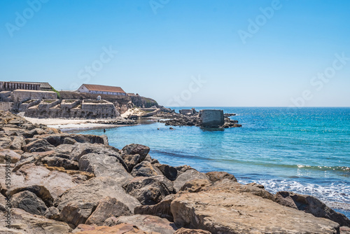 Selective focus in rocks with turquoise Atlantic Ocean and walls of the fort of the island of Las Palomas next to El Foso, Tarifa SPAIN photo