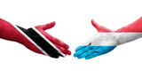 Handshake between Luxembourg and Trinidad Tobago flags painted on hands, isolated transparent image.