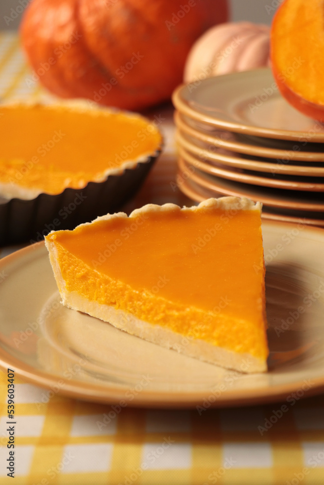 Plate with piece of fresh homemade pumpkin pie on table Plate with piece of fresh homemade pumpkin pie on table