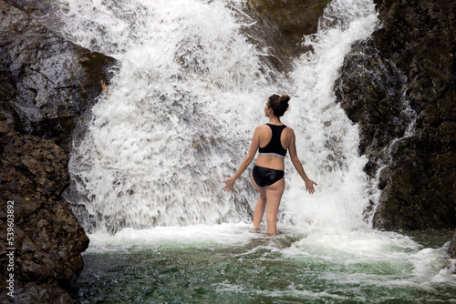 Mid Adult Woman Enjoying Moments Close To a Refreshing Waterfall in Summer
