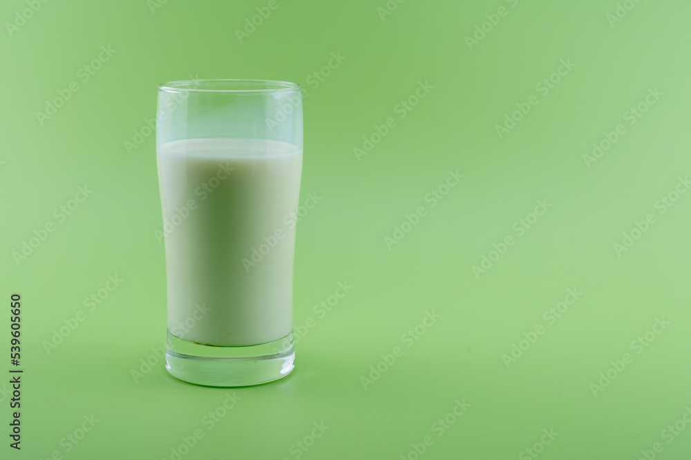 Glass of milk on green background,Healthy Lifestyle Glass of milk on green background,Healthy Lifestyle
