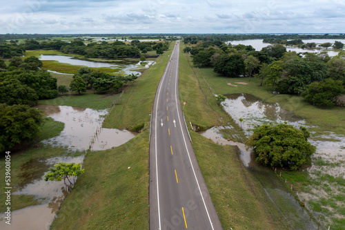 Highway in a rural landscape flooded by proximity to the Magdalena River in the department of Bolivar. Colombia . photo