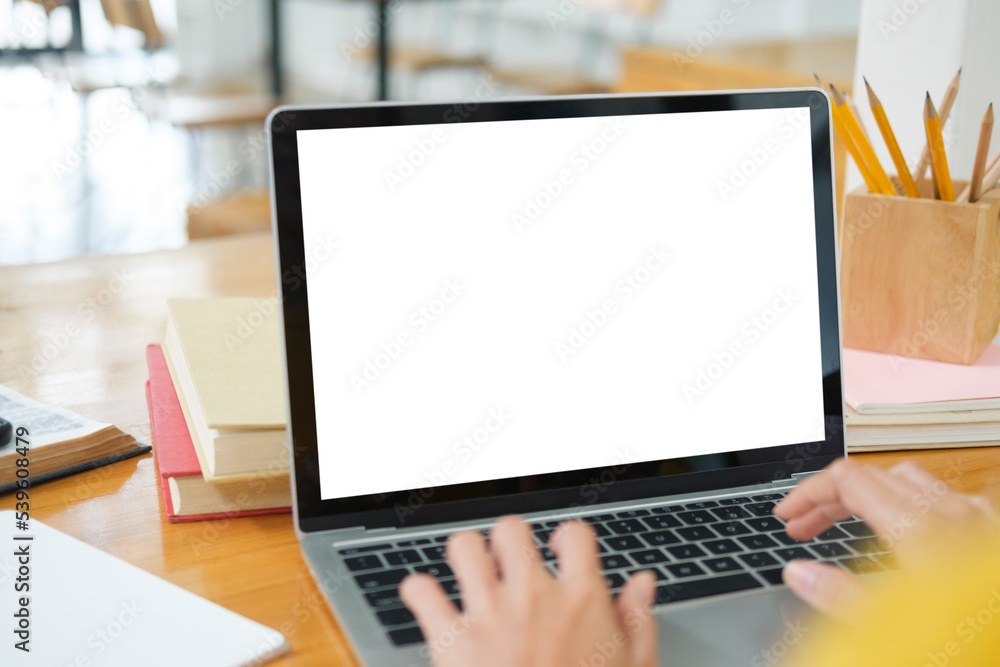 Close up of woman studying online using laptop with blank screen. Close up of woman studying online using laptop with blank screen.