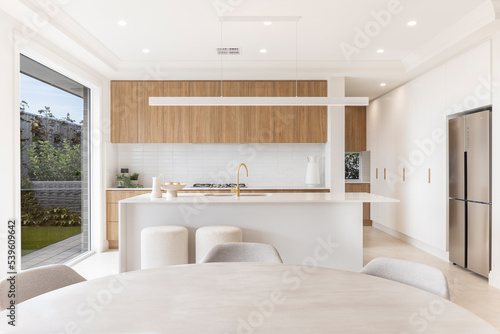 A new modern white with wood stylish kitchen and dining room table © REAP