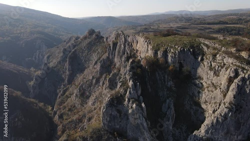 Stone rocks of the Nisevac near Svrljig in Serbia cliff and gorge rock on the mountain range in sunny day Aerial drone video over the hill photo