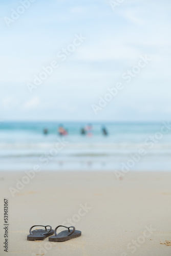shoes on the sand with sea background, relax background , nice ocean