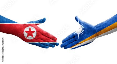 Handshake between Marshall Islands and North Korea flags painted on hands, isolated transparent image.