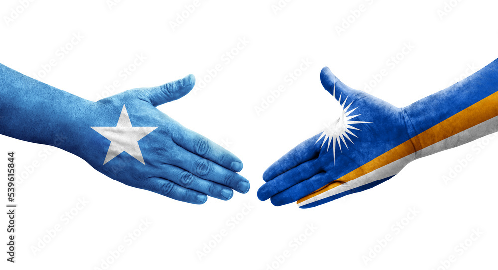 Handshake between Marshall Islands and Somalia flags painted on hands, isolated transparent image. Handshake between Marshall Islands and Somalia flags painted on hands, isolated transparent image.