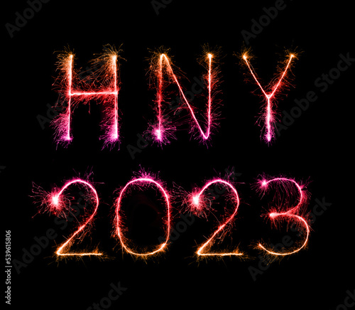 2023 (HNY) happy new year fireworks celebration written sparkling at night.