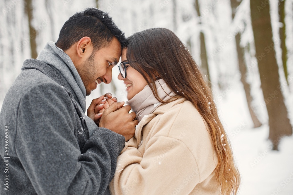 Fototapeta premium Portrait of a romantic couple spending time together in winter forest