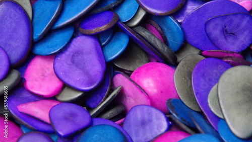 Cut and polished tagua nuts, dyed cool colors, at a tagua nut jewelry shop in Iluman, Ecuador photo