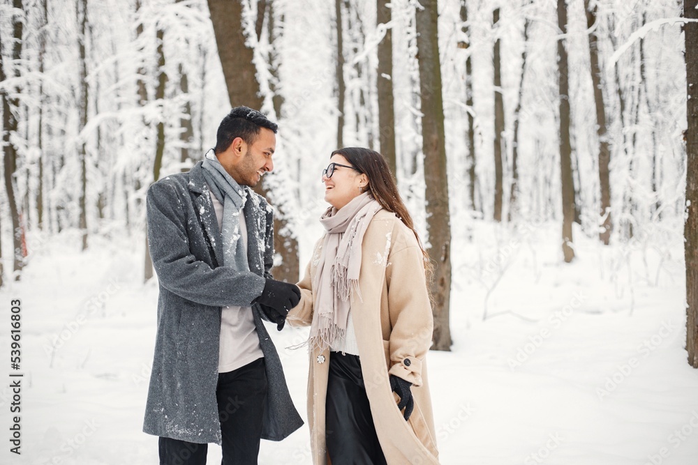 Portrait of a romantic couple spending time together in winter forest Portrait of a romantic couple spending time together in winter forest