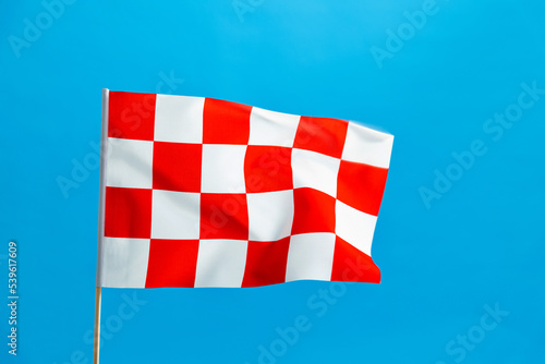 Checkered flag waving on blue background