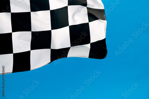 Checkered flag waving on blue background