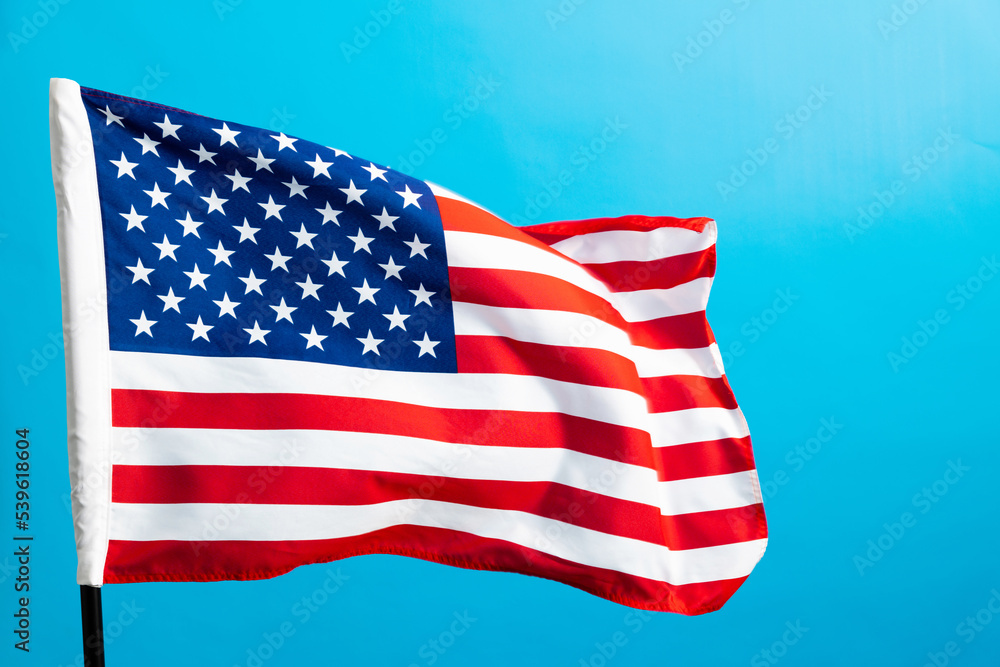 Fototapeta premium American flag waving on blue background