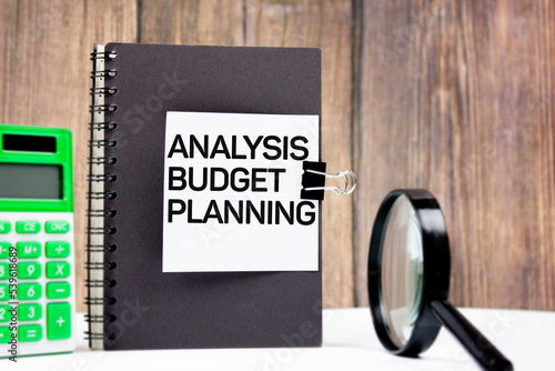 ANALYSIS, BUDGET AND PLANNING - text on paper on a notepad next to a calculator. Business strategy or study of opportunities to start a business in the market.