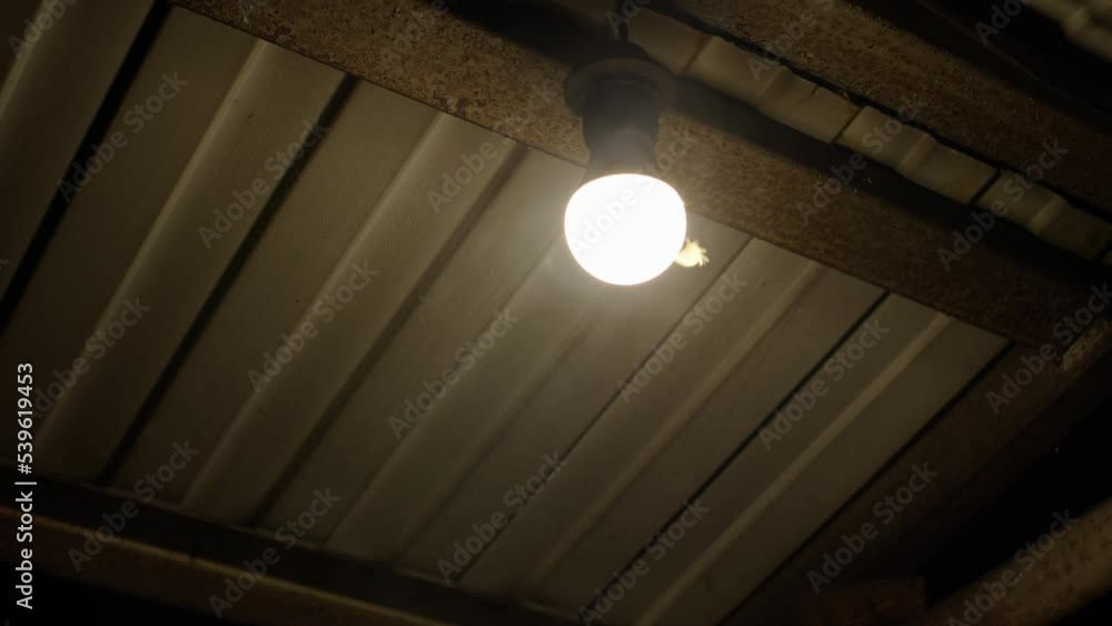 Bright LED lamp light with yellow light on street under iron roof, there smoke around and butterfly sits on lamp holder. concept of saving light and using eco-friendly things. Bright LED lamp light with yellow light on street under iron roof, there smoke around and butterfly sits on lamp holder. concept of saving light and using eco-friendly things.