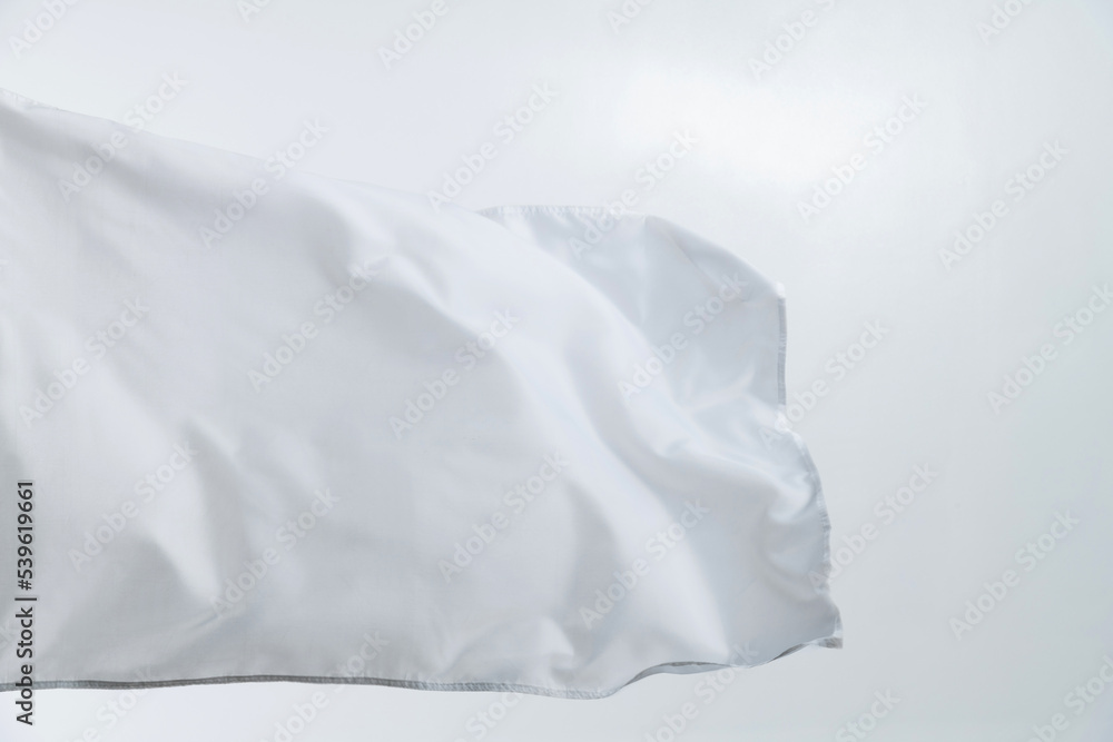 Obraz premium White flag waving on white background