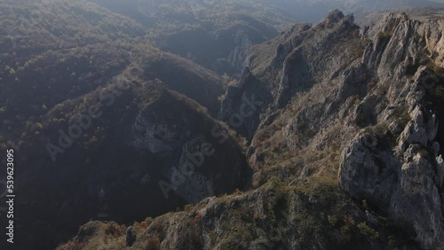 Stone rocks of the Nisevac near Svrljig in Serbia cliff and gorge rock on the mountain range in sunny day Aerial drone video over the hill photo