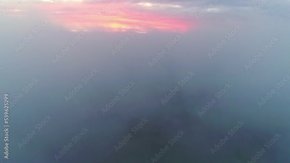 Aerial drone forward moving shot flying through fluffy white clouds along colorful sky during evening time. Cumulus white cloud cloudscape. Aerial drone forward moving shot flying through fluffy white clouds along colorful sky during evening time. Cumulus white cloud cloudscape.