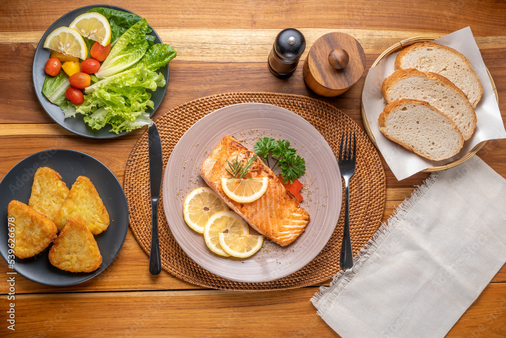 Salmon Steak, served with bread, ready to eat, Grilled Salmon with lemon. Salmon Steak, served with bread, ready to eat, Grilled Salmon with lemon.