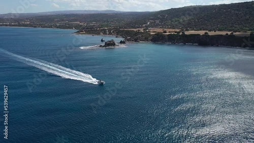 Speedboat passing Akamas peninsula in Chrysochou Bay, aerial tracking photo