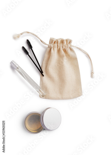 Mockup burlap bag for cosmetics, brushes for combing eyebrows, cream in jar and spray in bottle