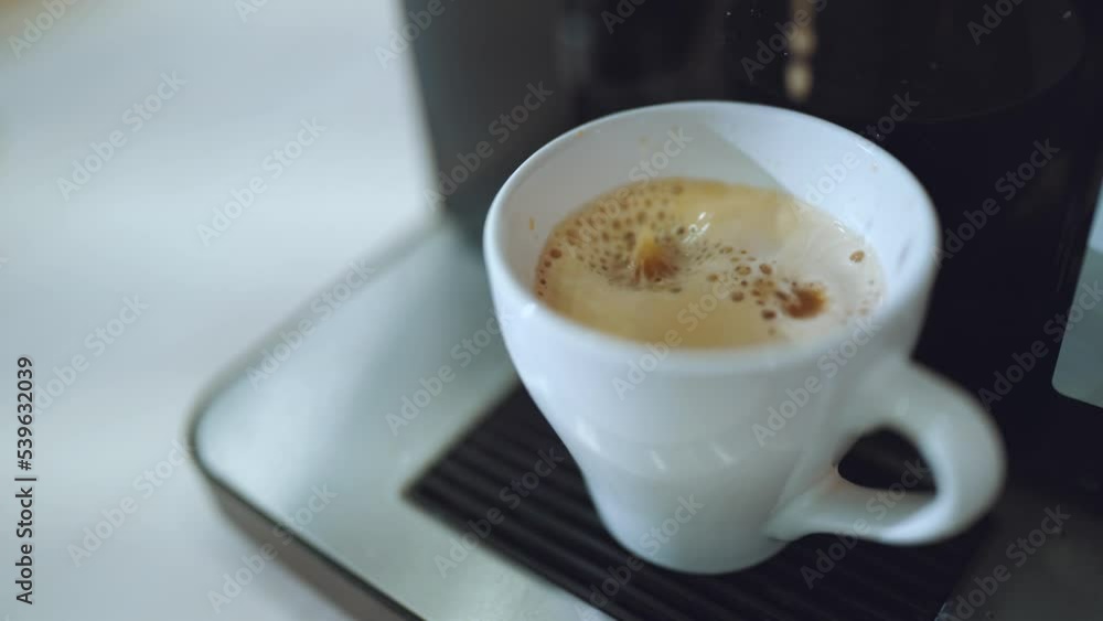 Coffee machine pours coffee, the process of making coffee in a coffee machine Coffee machine pours coffee, the process of making coffee in a coffee machine