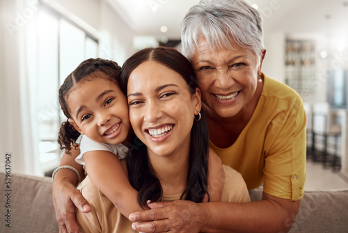 Fotografie Child, mother and grandmother portrait while at home on sofa with smile, love and support sharing hug for generation of senior, woman and child