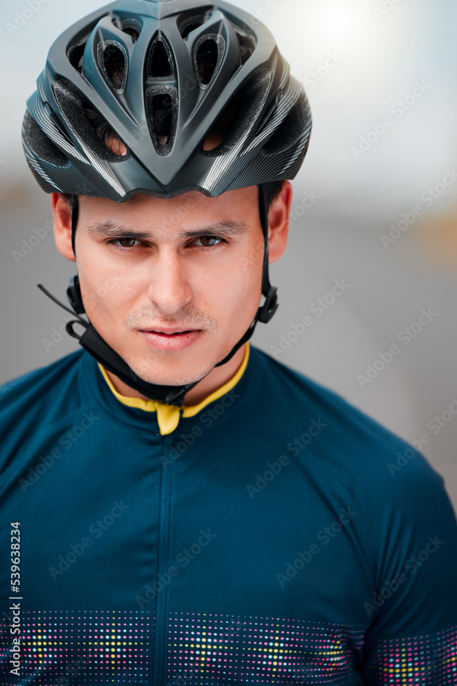Cycling, helmet and serious with a sports man outside, ready to ride or cycle for exercise and fitness. Workout, training and cardio with a male athlete riding with focus for health or endurance