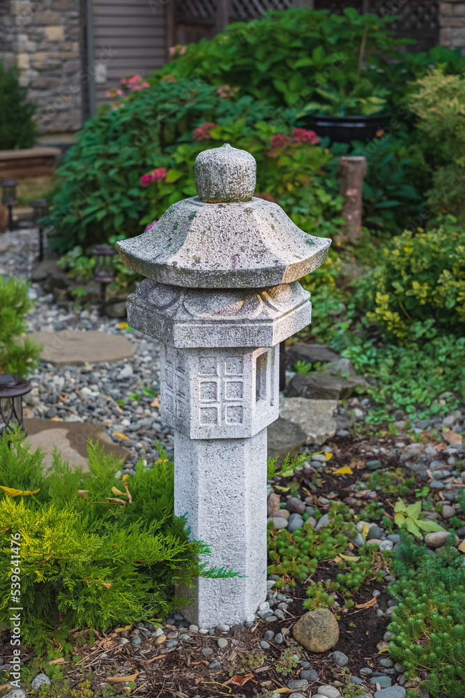 Japanese pagoda on a natural background. Stone pagoda in a garden Japanese pagoda on a natural background. Stone pagoda in a garden