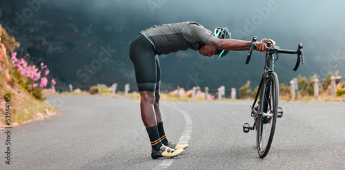 Sports man, stretch and cycling break along mountain route by cyclist resting during fitness, exercise and morning cardio. Stretching, bicycle and black man stop for rest during physical performance
