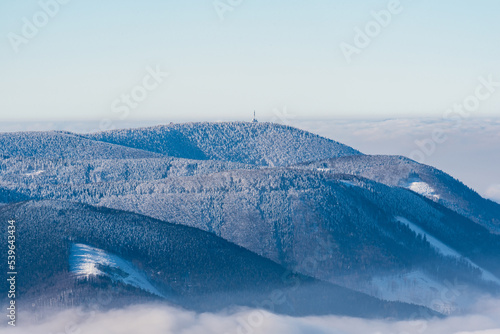Radhost hill from Lysa hora hill in winter Moravskoslezske Beskydy mountains in Czech republic photo