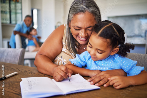 Foto Learning, writing and notebook with grandma and girl for education, study and family help with homework