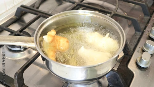 SFINCI Traditional Sicilian Italian Fried Doughnuts while frying in vegetable oil photo