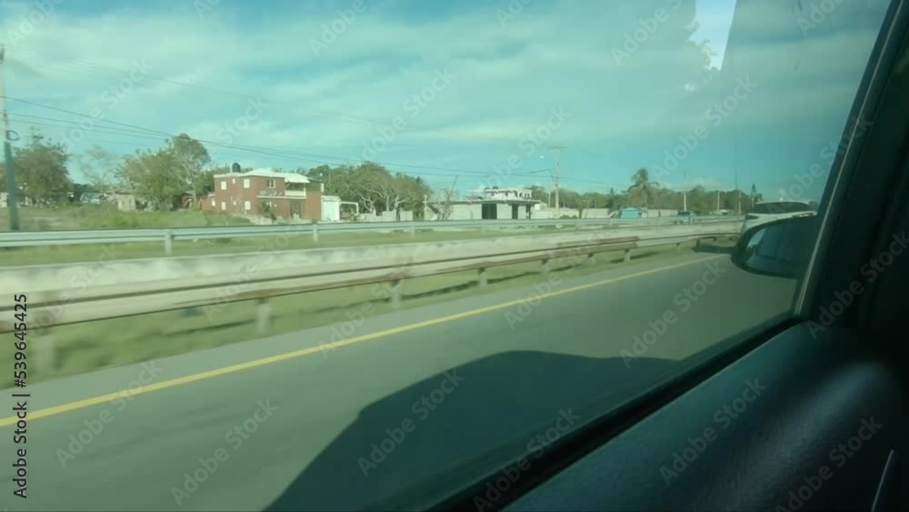 Juan Dolio, Dominican Republic - 2022: First person view of the main highway from inside a car, traveling around the country. Juan Dolio, Dominican Republic - 2022: First person view of the main highway from inside a car, traveling around the country.