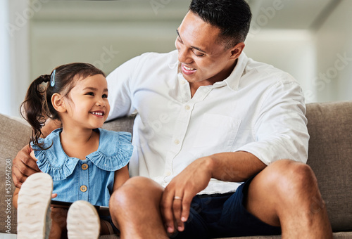 Father, girl and happy living room bonding quality time at a family home with love and care on a sofa. Dad and young child smile on a couch with happiness relax smiling in a house lounge together