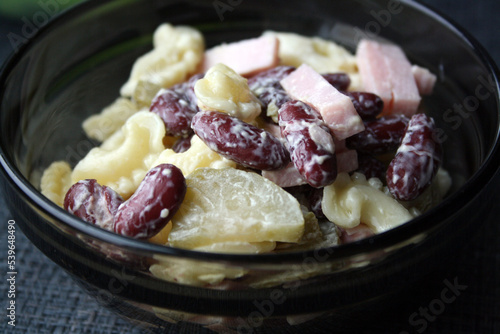 Salad of pasta, ham, beans and pickled cucumbers. Belgian cuisine.