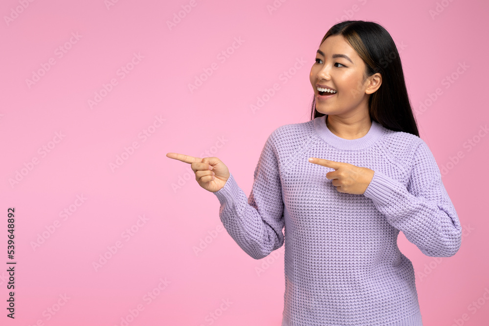 Young woman pointing finger away at the empty copy space, advertising concept Young woman pointing finger away at the empty copy space, advertising concept