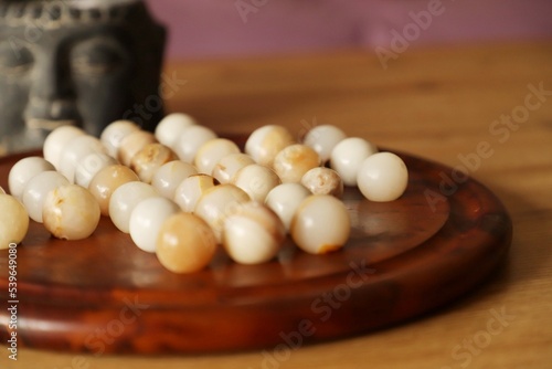 pearl necklace on wooden background