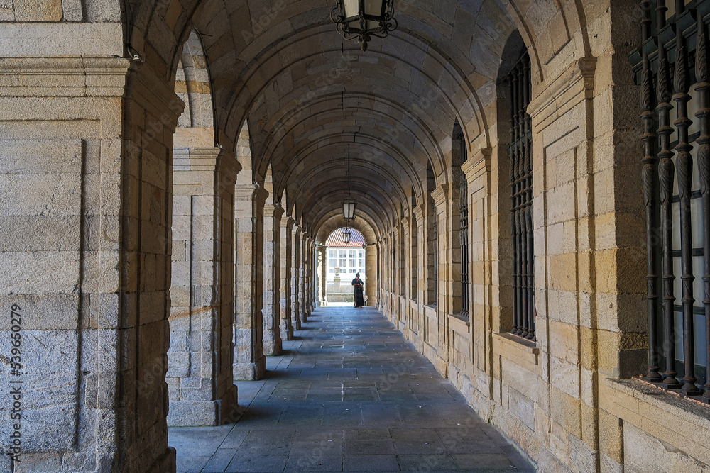 Portico of the Palacio de Rajoy with a person in the background, City Hall of Santiago de Compostela, Galicia, Spain.