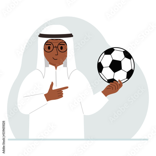 A man holds a soccer ball in his hand. The concept of a player, fan or coach.